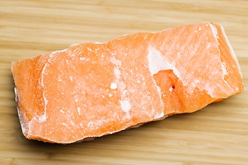 Image showing Slice of salmon on the table closeup