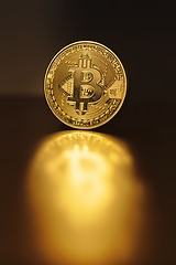 Image showing Physical shiny bitcoin agains dark background