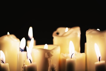 Image showing Candles glowing against dark background