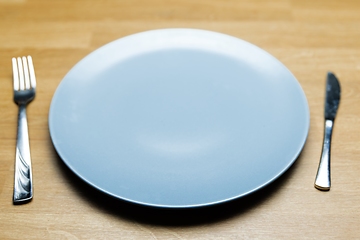 Image showing Empty dish on table with fork and knife