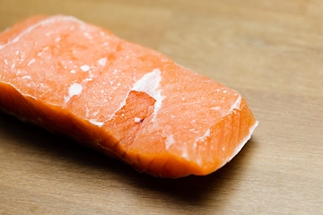 Image showing Slice of salmon on the table closeup