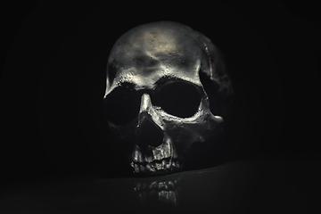 Image showing Spooky dark black skull aginast dark background