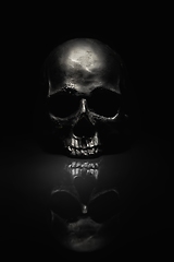 Image showing Spooky dark black skull aginast dark background