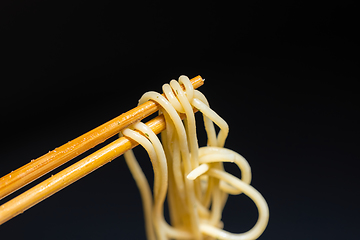 Image showing Spaghetti closeup photo on chopsticks