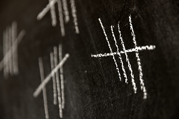 Image showing Counting with lines on dark black chalk board