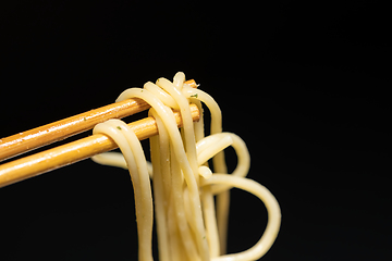 Image showing Spaghetti closeup photo on chopsticks