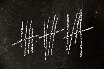 Image showing Counting with lines on dark black chalk board