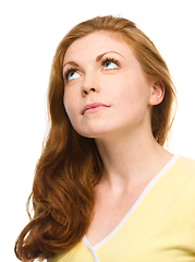 Image showing Young happy woman is looking up and smile