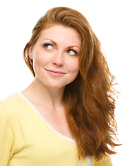 Image showing Young happy woman is looking up and smile