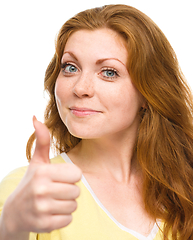 Image showing Woman is showing thumb up gesture