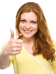 Image showing Woman is showing thumb up gesture