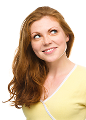 Image showing Young happy woman is looking up and smile