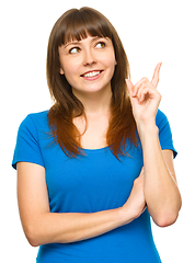 Image showing Portrait of a young woman pointing to the right