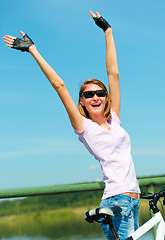 Image showing Young woman raised her hands up in joy