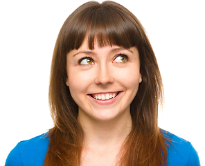 Image showing Young happy woman is looking up and smile