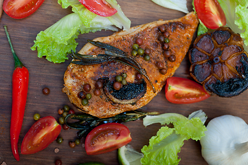 Image showing wood fired hoven cooked chicken breast on wood board 