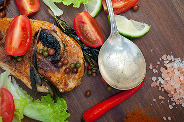 Image showing wood fired hoven cooked chicken breast on wood board 