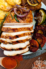 Image showing roasted grilled BBQ chicken breast with herbs and spices 