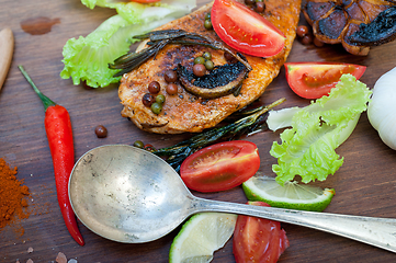 Image showing wood fired hoven cooked chicken breast on wood board 