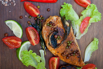 Image showing wood fired hoven cooked chicken breast on wood board 