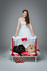 Image showing Bride girl with Spitz dog wedding couple on bed