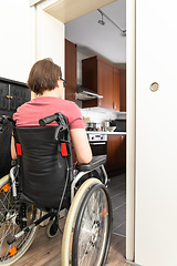 Image showing disabled woman at the open door to the kitchen