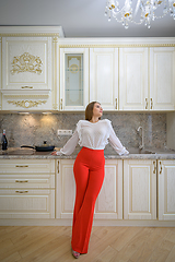 Image showing Young woman at luxury classic white kitchen interior in provence style