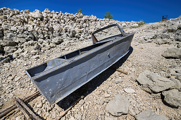 Image showing Empty old metal fishing motor boat at shore