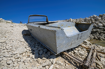 Image showing Empty old metal fishing motor boat at shore