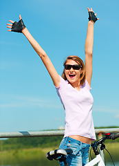 Image showing Young woman raised her hands up in joy