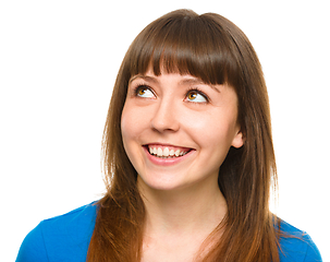 Image showing Young happy woman is looking up and smile