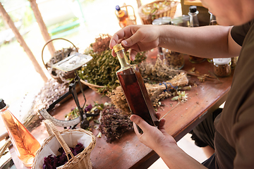 Image showing potion bottle in hand of herbalist