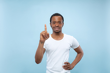 Image showing Half-length close up portrait of young man on blue background.