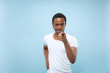 Image showing Half-length close up portrait of young man on blue background.