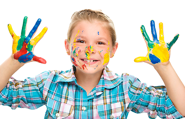 Image showing Portrait of a cute girl playing with paints