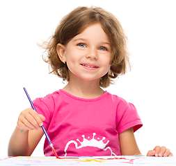 Image showing Little girl is painting with gouache