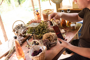 Image showing potion bottle in hand of herbalist