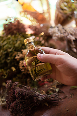 Image showing potion bottle in hand of herbalist