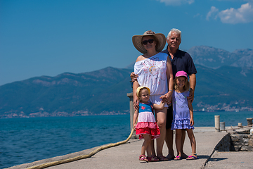 Image showing portrait of grandparents and granddaughters standing by the sea