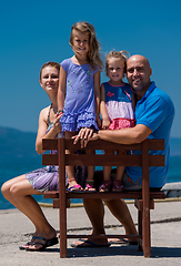 Image showing portrait of young happy family with daughters by the sea