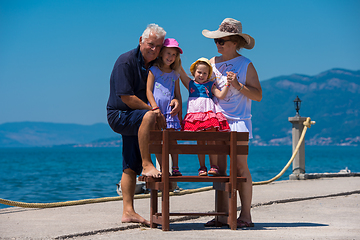 Image showing portrait of grandparents and granddaughters by the sea
