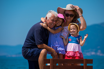 Image showing portrait of grandparents and granddaughters by the sea