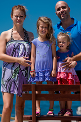 Image showing portrait of young happy family with daughters by the sea