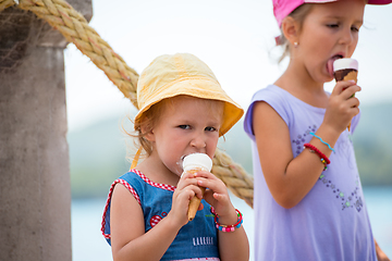 Image showing little girls eating ice cream by the sea