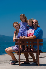 Image showing portrait of young happy family with daughters by the sea