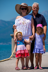 Image showing portrait of grandparents and granddaughters standing by the sea