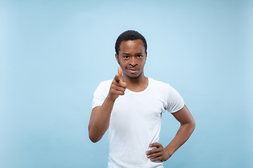 Image showing Half-length close up portrait of young man on blue background.