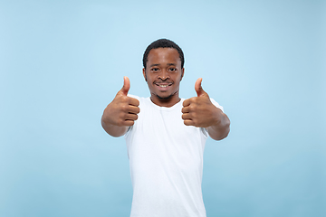 Image showing Half-length close up portrait of young man on blue background.