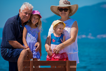 Image showing portrait of grandparents and granddaughters by the sea