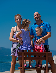 Image showing portrait of young happy family with daughters by the sea